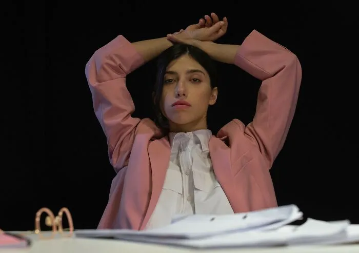 Woman in a suit leaning back at her desk discussing strange real laws