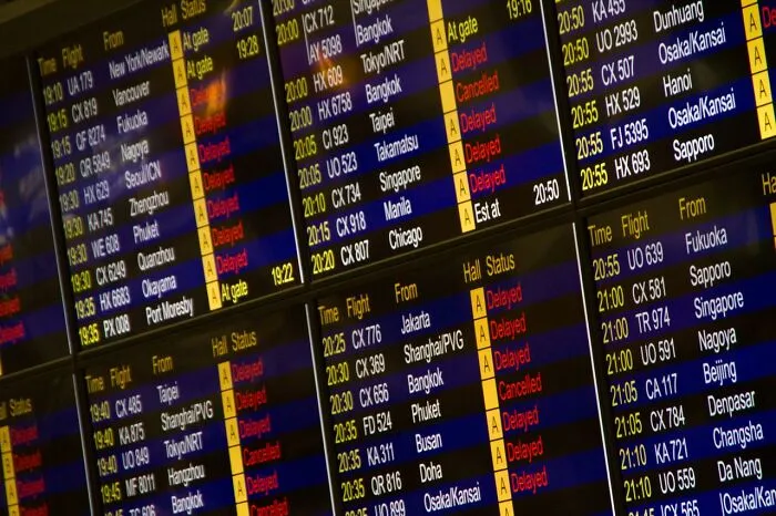 Airport departure board showing flight schedules, a clever life trick for managing travel delays.