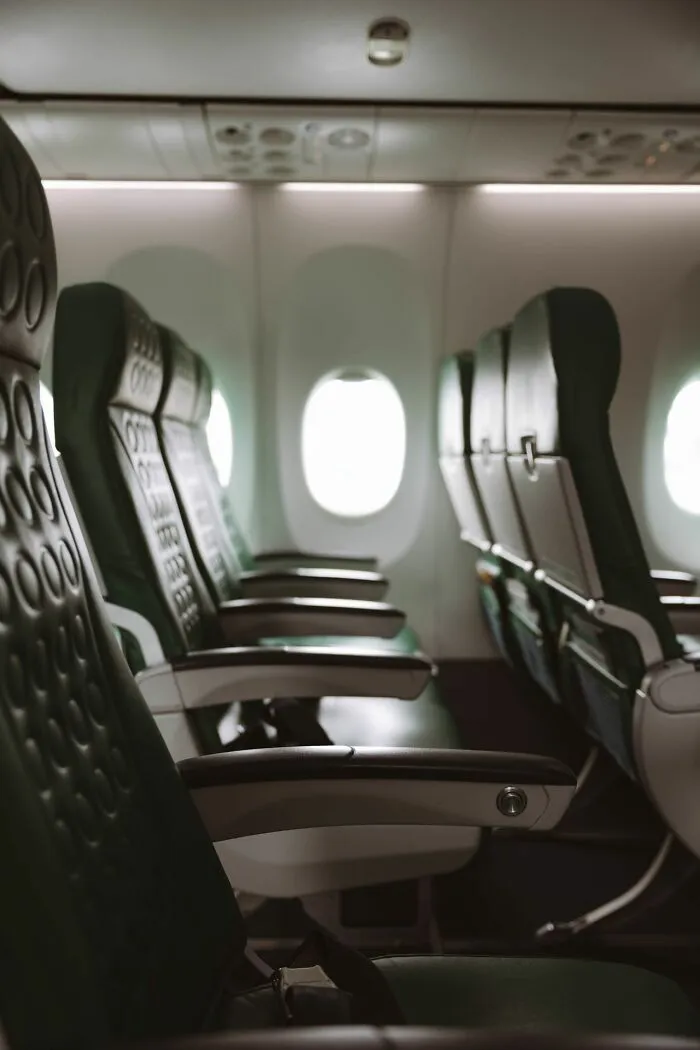 Empty seats in an airplane cabin representing clever life tricks for comfortable travel