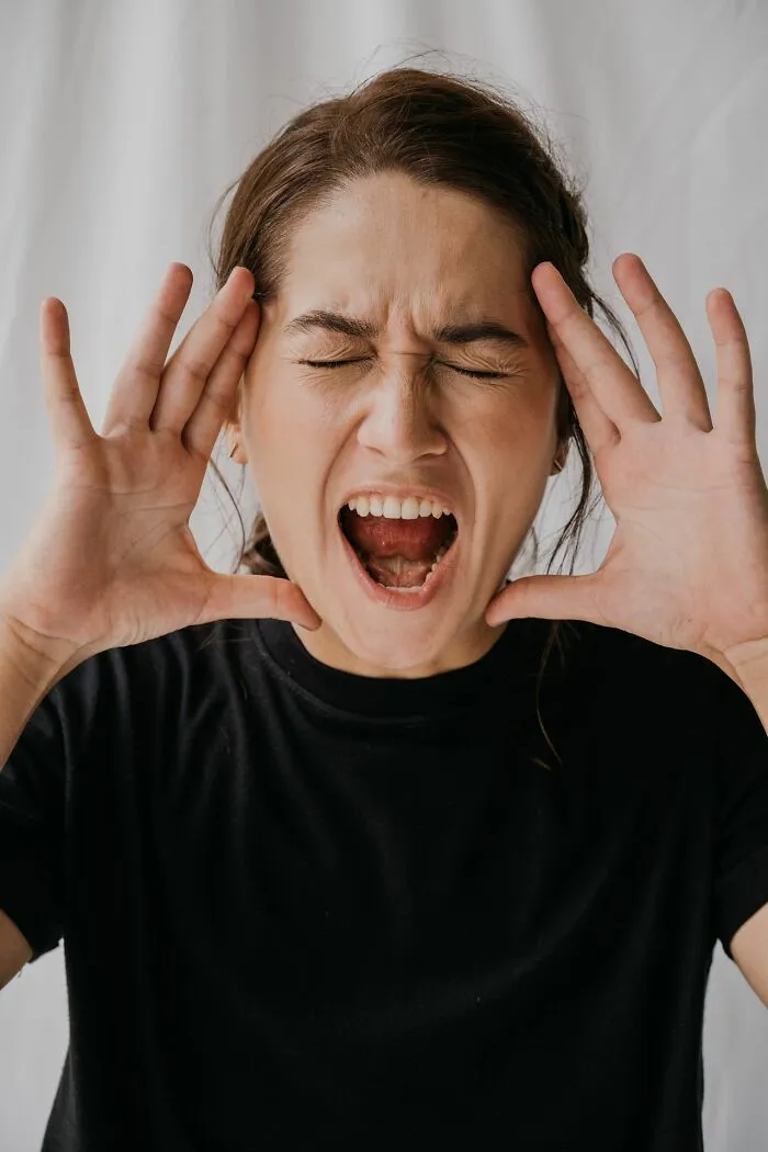 Stressed woman shouting showing emotions linked to kids' embarrassing Karen stories
