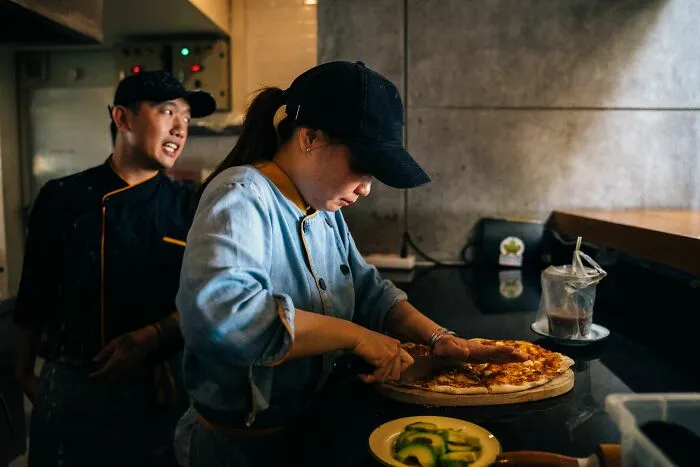 Chefs preparing food in a restaurant kitchen for their jobs