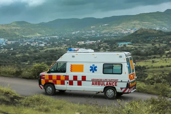 Ambulance driving down a rural road, representing satisfying revenge stories.
