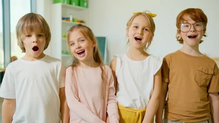 Four happy children standing together, representing companies people refuse to give another dollar to.