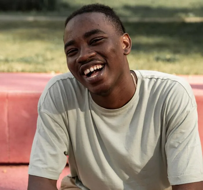 Smiling man outdoors, showing resilience against microaggressions