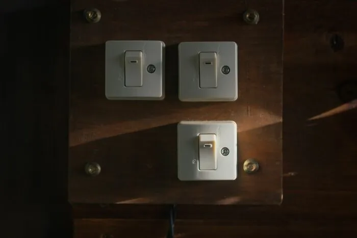 Light switches on wooden panel symbolizing lowkey acts to get back at an ex