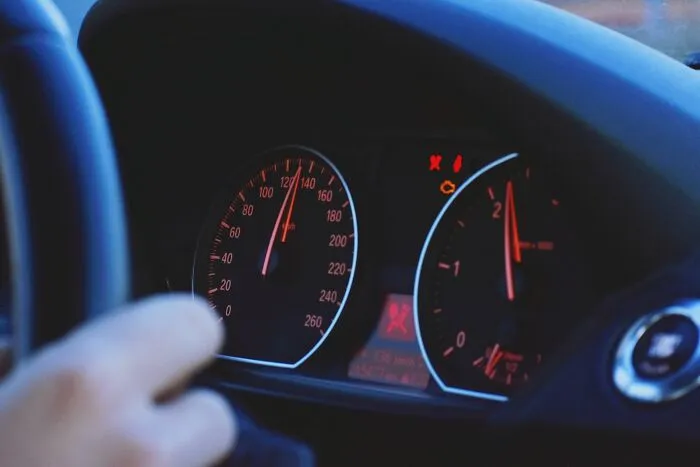  Illuminated car dashboard speedometer highlighting unique driving laws and rules