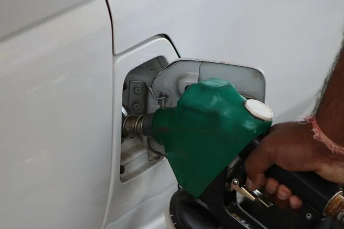 Hand fueling a white vehicle representing unhinged things people did to get back at their ex