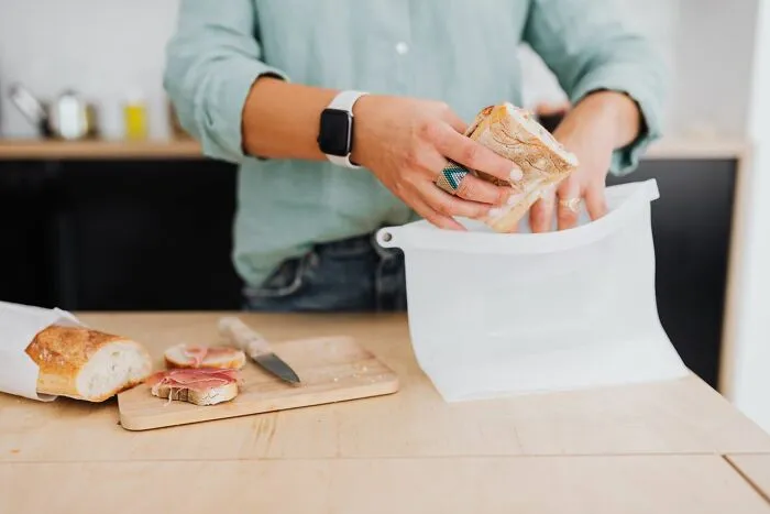 Person storing bread in reusable bag practical life hacks