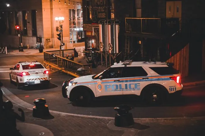 Police cars parked on a city street at night, responding to funny instances when folks failed embarrassingly.