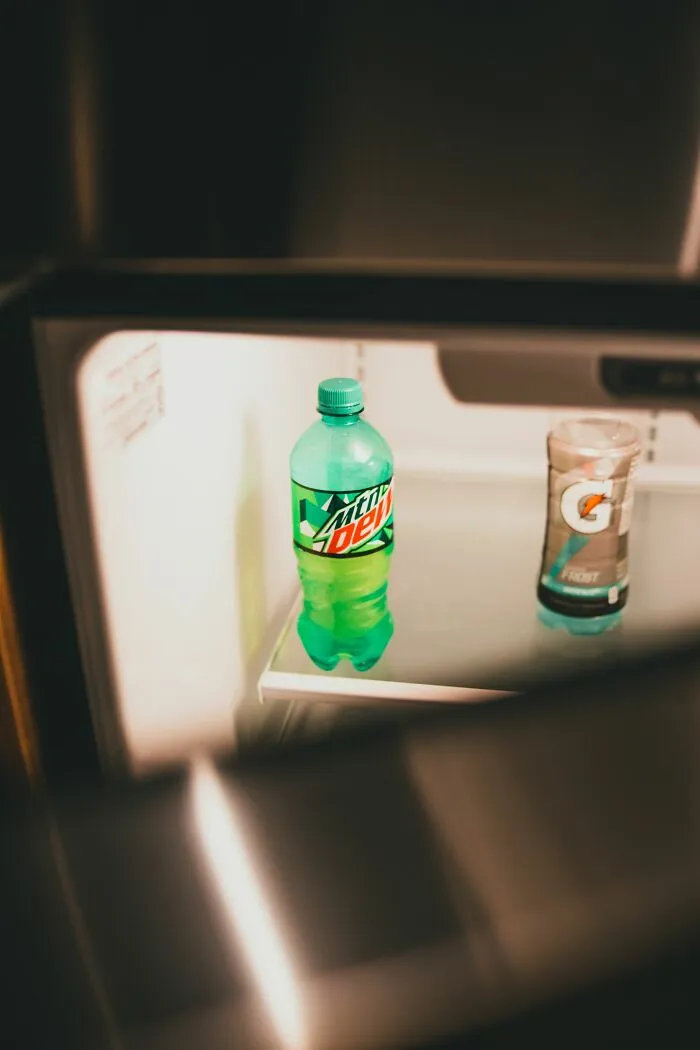 Bottles of Mountain Dew and Gatorade inside a refrigerator, related to lifestyle advice from doctors and nurses.