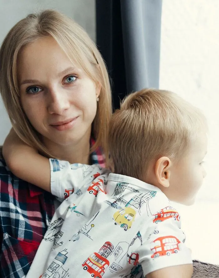 A young mother holding her child, reflecting on things women wish they had known