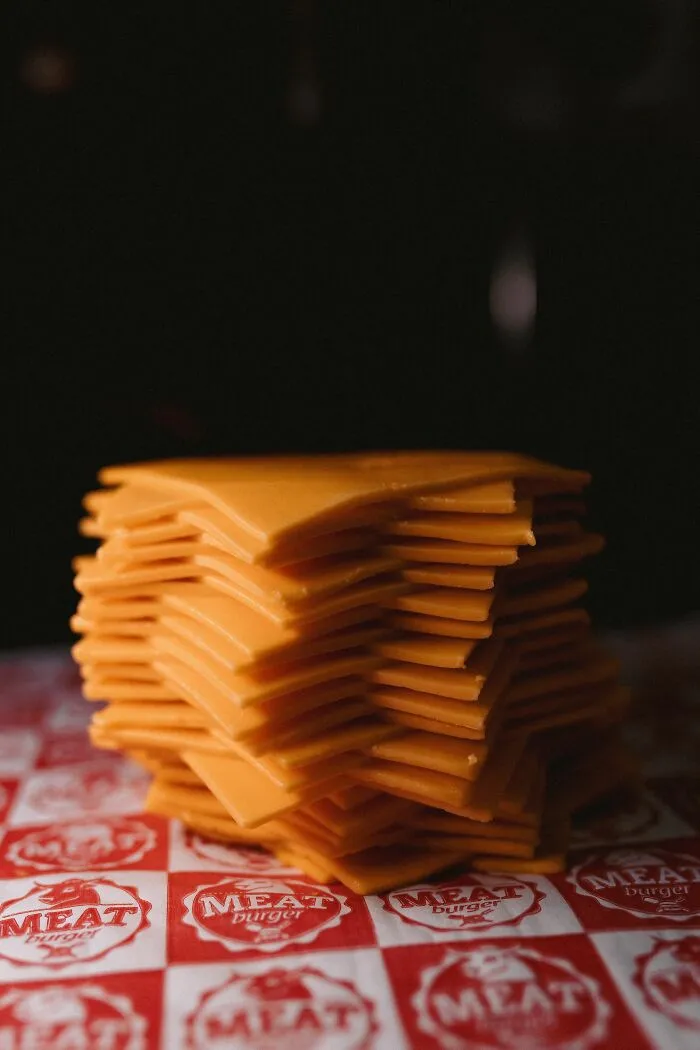 Stack of sliced cheddar cheese bringing drama to tiny communities