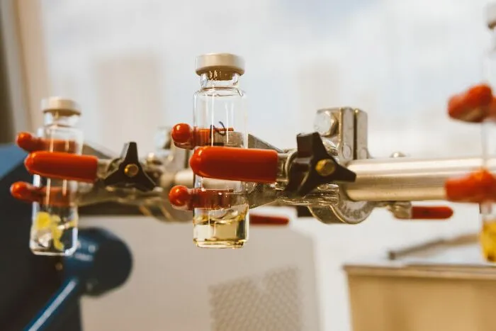 Laboratory glass vials in a test setup representing controversial companies consumers refuse to fund