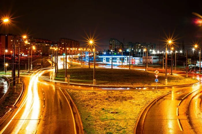 Long exposure shot of city road traffic lights at night, illustrating clever life tricks for urban navigation.