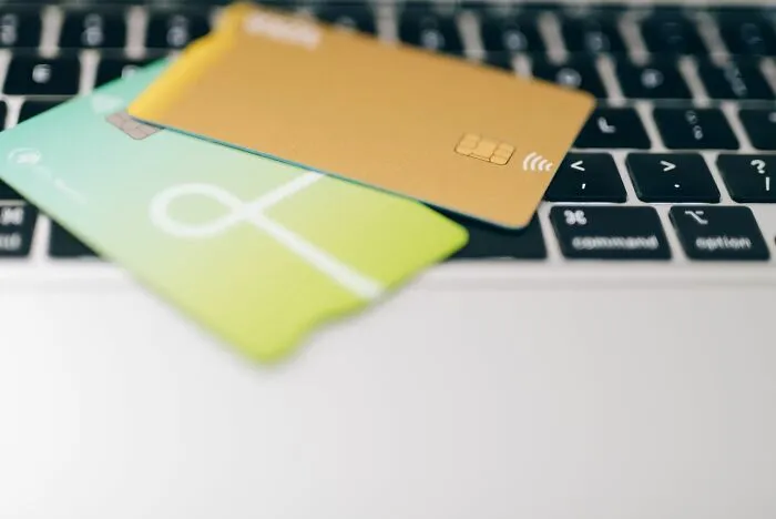 Two credit cards resting on a laptop keyboard demonstrating clever life tricks for smart shopping