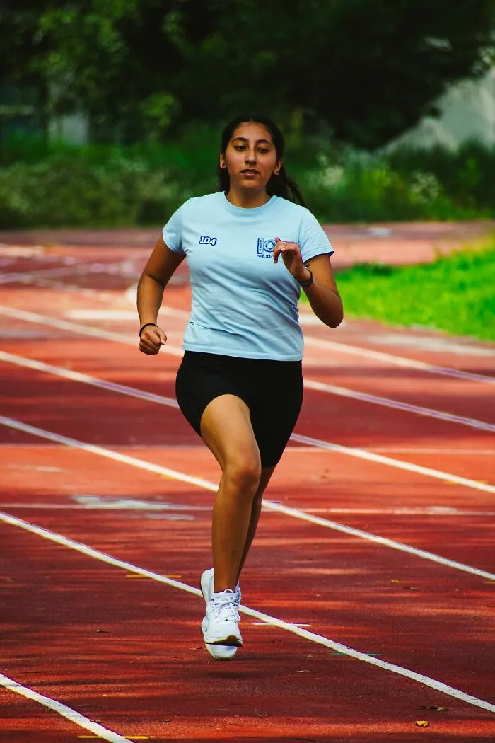 A woman running on a track, depicting the fast action needed to leave immediately.