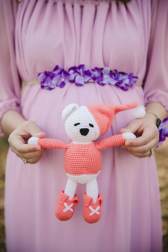 A pregnant woman holding a crocheted teddy bear, illustrating school rumors about students
