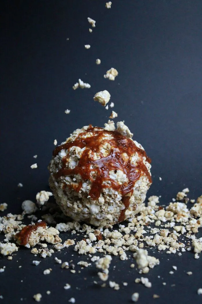 A sticky popcorn ball drizzled with caramel received while trick-or-treating instead of candy.