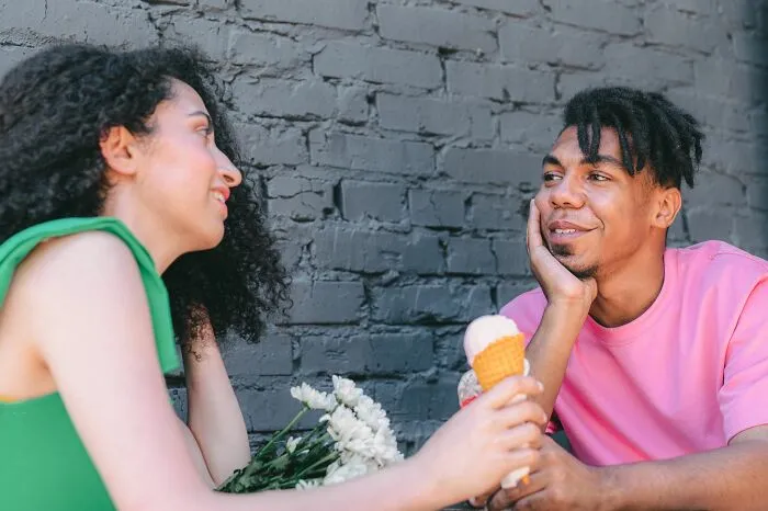 Couple chatting and smiling holding ice cream about microaggressions women encounter