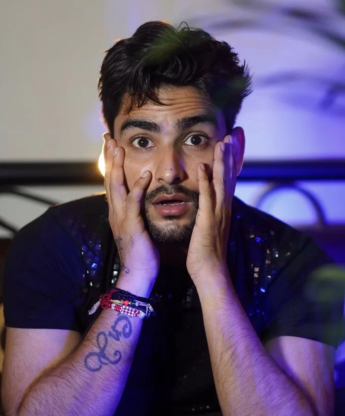 A shocked man holding his face, reflecting a costly single slip-up that led to a massive bill.