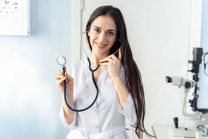 A female doctor holding a stethoscope, related to dumb things professionals said in healthcare settings