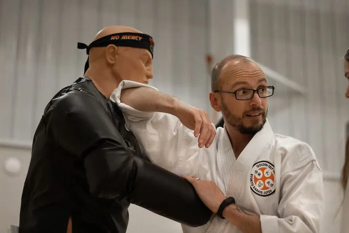 Martial arts instructor demonstrating a defensive move related to microaggressions women face
