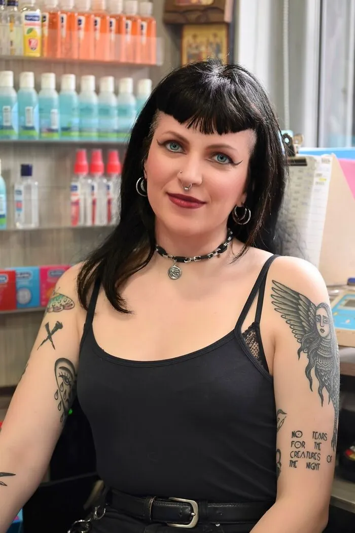 A woman with tattoos looking at the camera, featured in satisfying revenge stories.