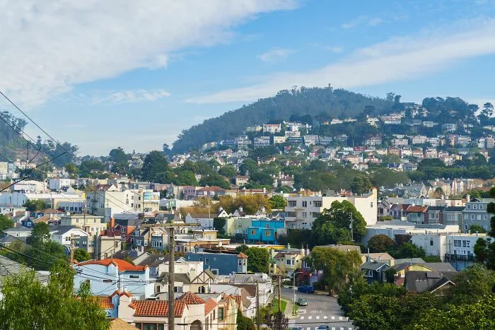 Densely packed houses on a hillside in tiny communities filled with local drama