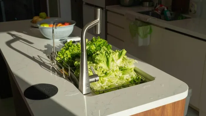 Fresh lettuce drying in kitchen sink with life hacks for food storage