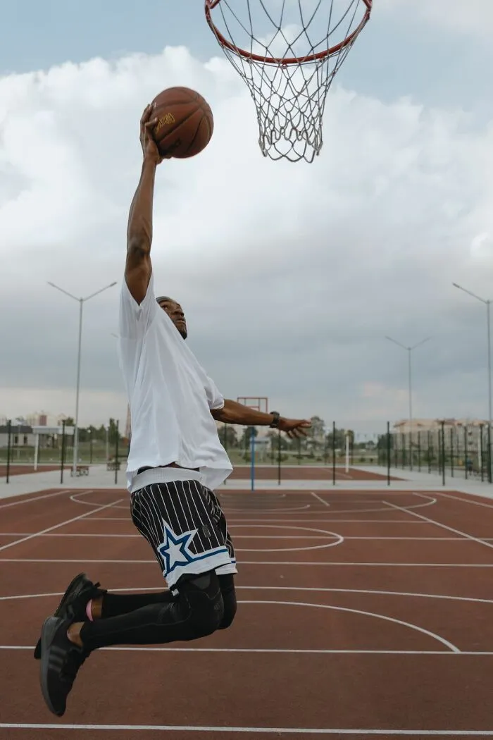 A basketball player dunking a ball, representing school rumors about sports achievements