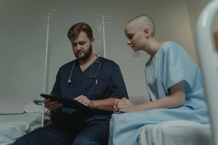 Doctor discussing medical information with female patient in hospital