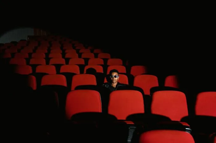 A person wearing 3D glasses sitting alone in a movie theater highlighting clever life tricks