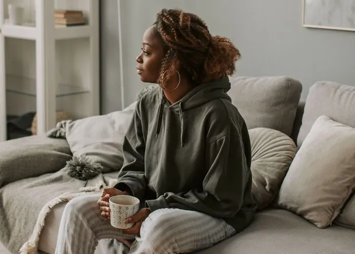 Thoughtful woman on sofa reflecting on hidden secrets folks take to the grave.