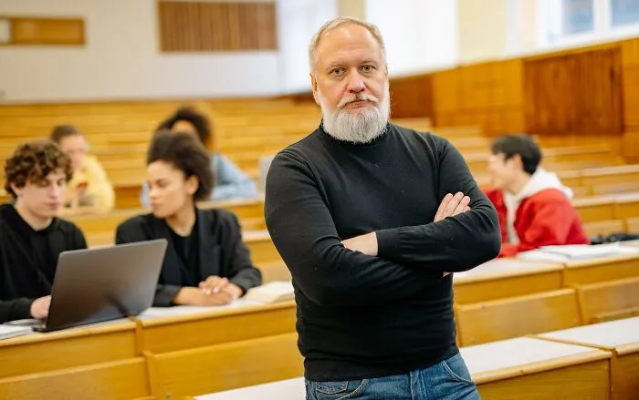 Professor with arms crossed in a lecture hall with students, discussing strange laws and loopholes.