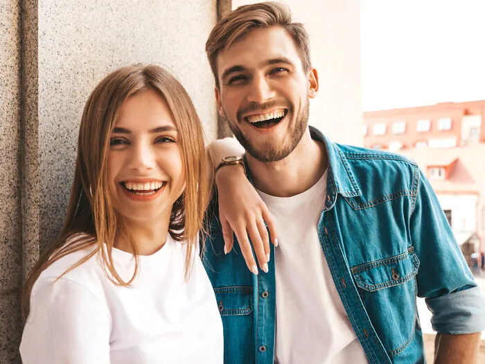 A happy young couple smiling together, sharing moments of joy