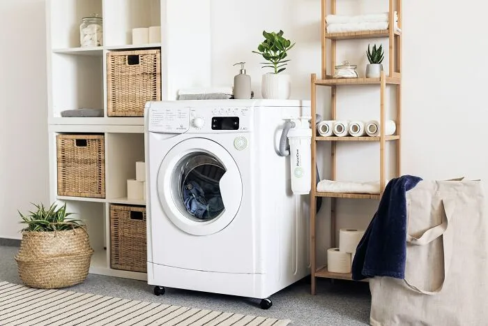 Modern laundry room with washing machine and storage baskets