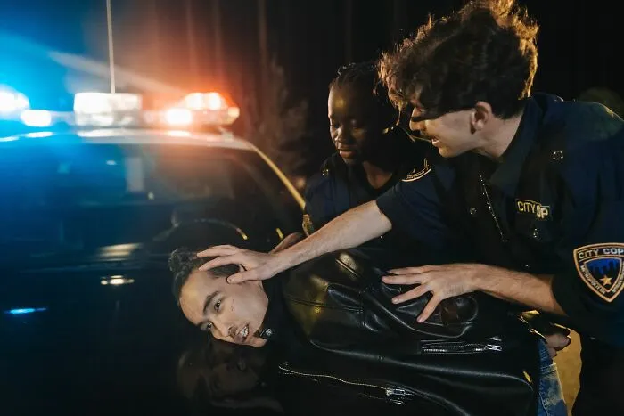 Police officers arresting a suspect at night, depicting someone who got fired during their first week