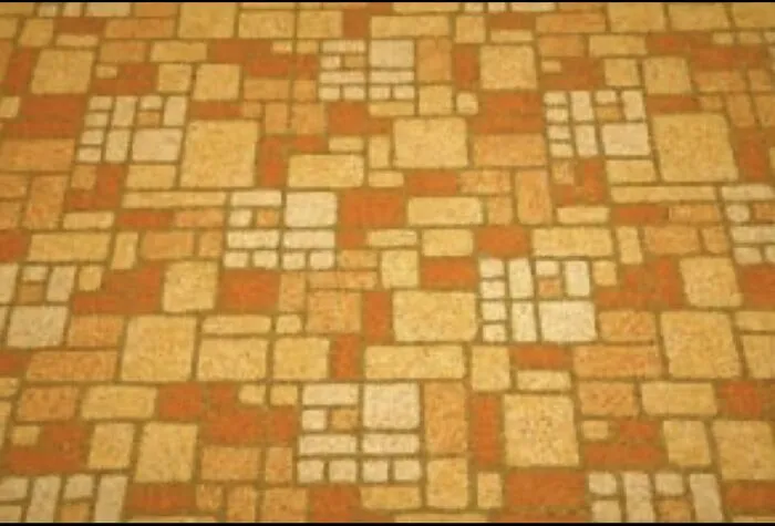 Retro orange and beige patterned linoleum flooring popular during 80s kids childhoods.