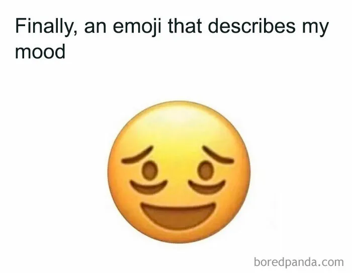 A tired yet smiling emoji with dark circles, illustrating a relatable mood in random memes