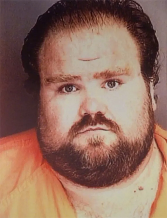 Mugshot of a heavy-set man with a beard, a convict who survived lethal injection.