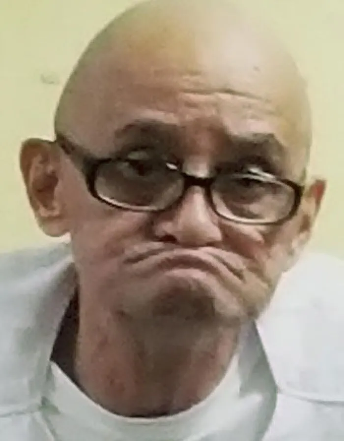 A smiling man looking sideways, one of the individuals who survived lethal injection.
