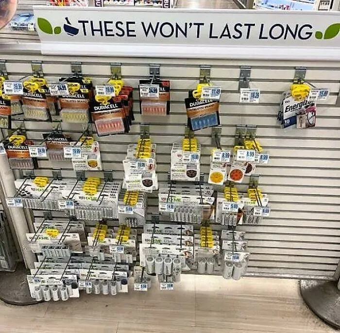 Store display of batteries under a sign saying these won't last long, an advertising fail.