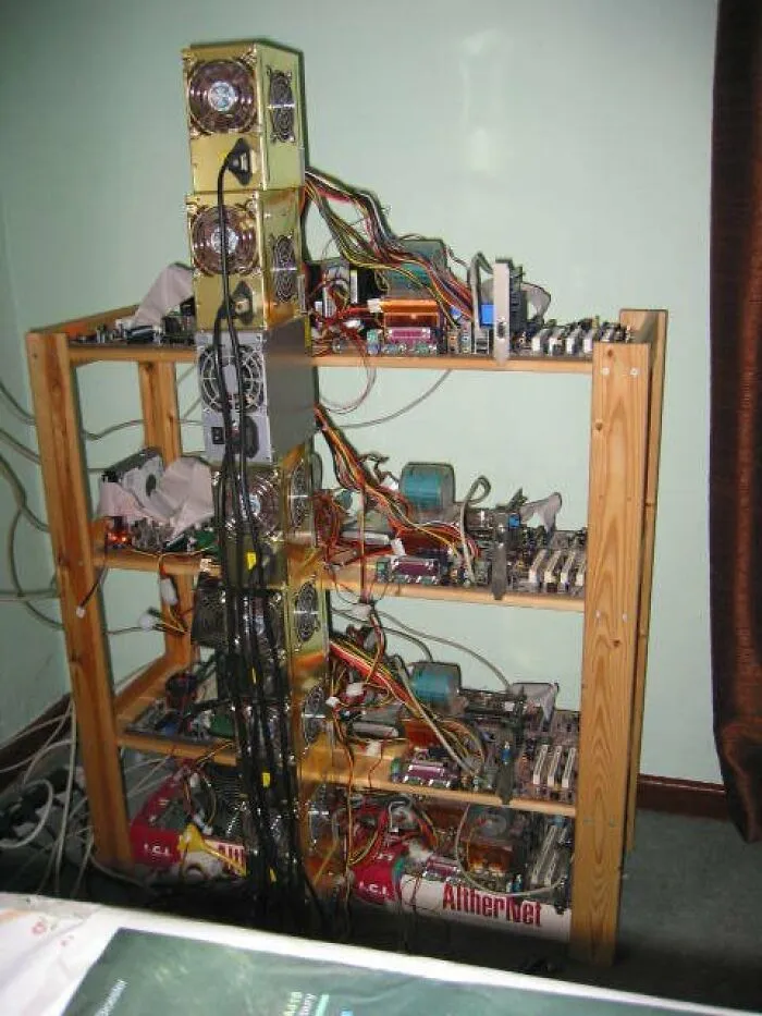A homemade computer server setup built on wooden shelves, showing creative redneck fixes.