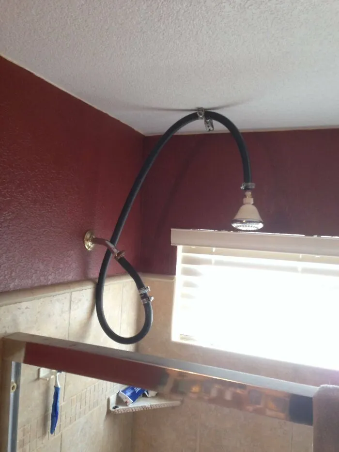 Creative redneck fixes featuring an extended rubber hose attached to a shower head.
