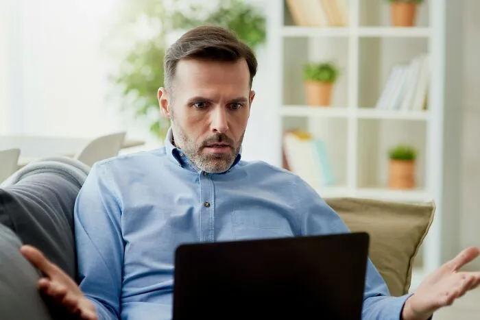 Confused employee staring at a laptop demonstrating bad bonuses and out of touch bosses