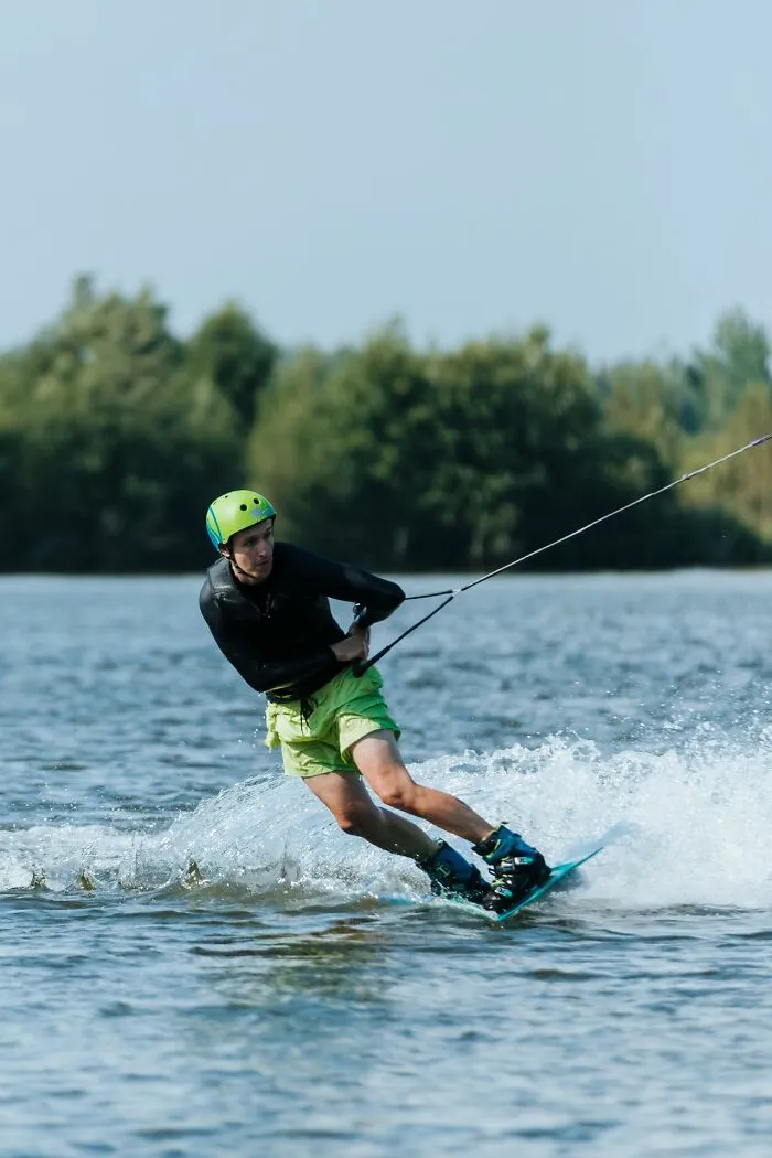 A man wakeboarding on a lake, representing out of touch bosses and management bonuses.