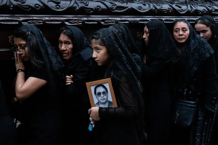 Women in black veils at a funeral holding framed photo, best pics Siena International Photo Awards 2026