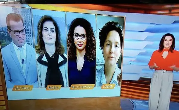 A news anchor appearing to stand beside her own broadcast screen in a perfectly confusing perspective.