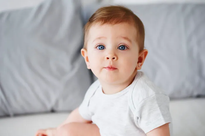 A cute baby with blue eyes looking surprised, illustrating a story about insensitive doctors.