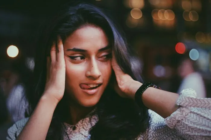A close-up of a young woman sticking her tongue out, showcasing behaviors they refuse to tolerate.